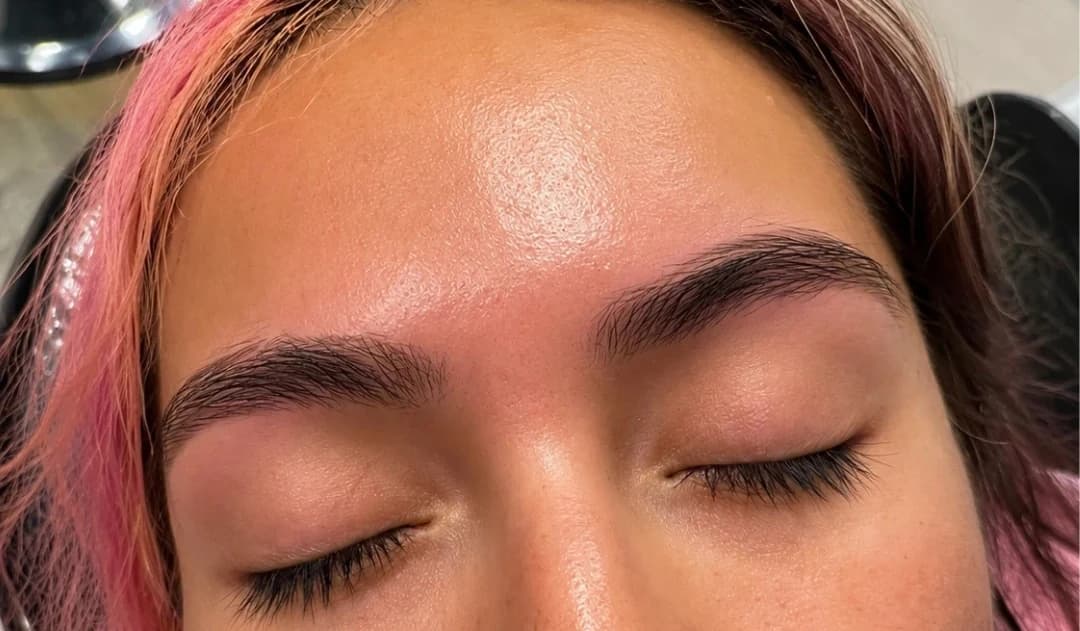 The same client's brows after threading — clean, defined arch